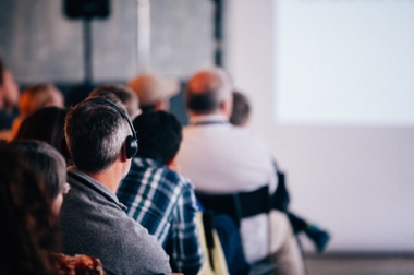 Student with earphones listening interpretation of an event